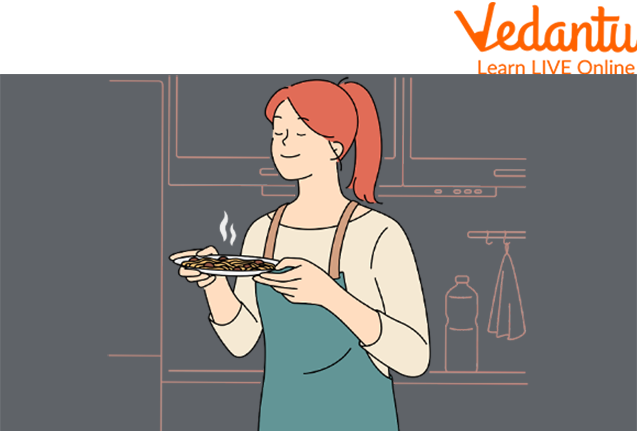 A Girl Smelling Food